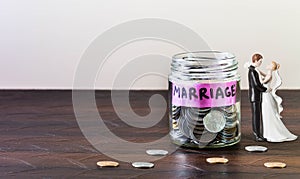 Glass jar full of coins and Marriage is Labelled.