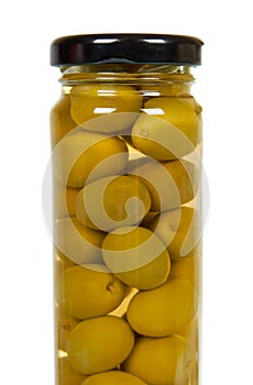 Glass jar with green olives. Canning supply food