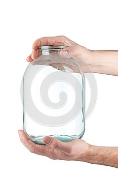 Glass jar in hand on white background