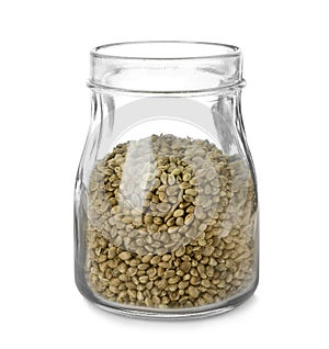 Glass jar of hemp seeds on white