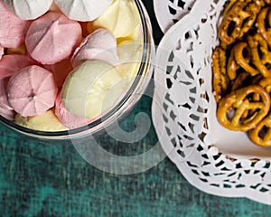 Glass jar with homemade sweet marhmellows, cookies in tablecloth