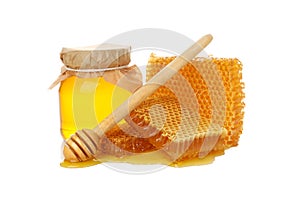 Glass jar of honey, dipper and honeycomb isolated on white