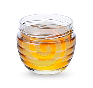 Glass jar with honey on white background