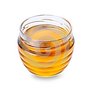 Glass jar with honey on white background