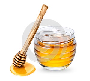 Glass jar with honey and wooden honey dipper on white background