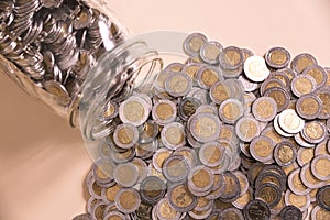 Glass jar with many mexican pesos photo