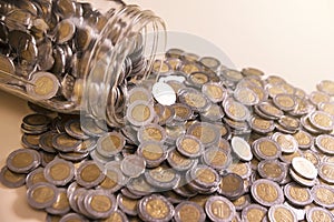 Glass jar with many mexican pesos photo