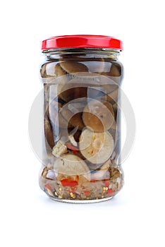 Glass jar with marinated milk mushrooms