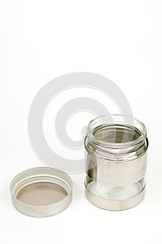 Glass jar in metal over white background