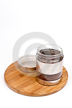 Glass jar in metal over white background