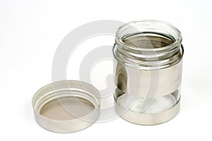 Glass jar in metal over white background