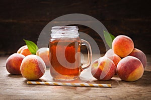 glass jar of peach iced tea with fresh fruits