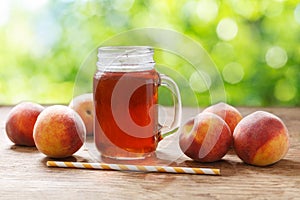 Glass jar of peach iced tea with fresh fruits