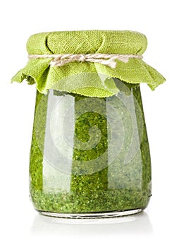 Glass jar of pesto sauce photo