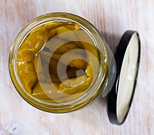 Glass jar with pickled green hot pepper
