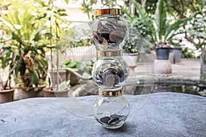 Glass jar piggy bank with coins. Plan your savings, run a growing business for success and save for retirement