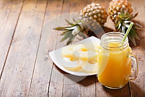 Glass jar of pineapple juice with fresh fruits