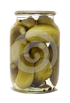 Glass jar with preserved cucumbers