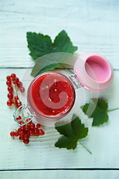 A glass jar of red currant jam