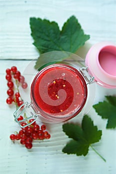 A glass jar of red currant jam