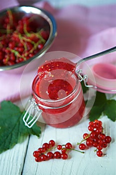 A glass jar of red currant jam