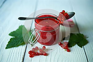 A glass jar of red currant jam