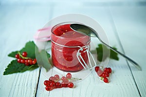 A glass jar of red currant jam