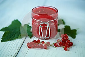 A glass jar of red currant jam