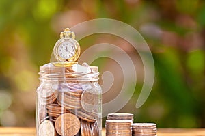 Glass jar with retro clock for time to money saving for retirement concept