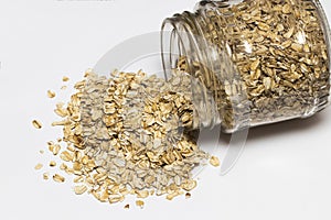 Glass jar with rolled oats isolated on white background