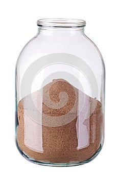 Glass jar with sand on white background