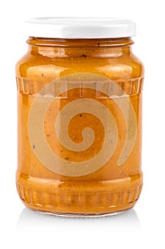 Glass jar with squash caviar on white background