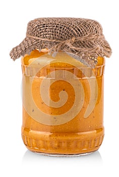 Glass jar with squash caviar on white background