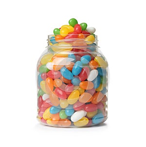 Glass jar of tasty bright jelly beans on white