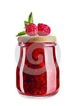 Glass jar with tasty raspberry jam on white background