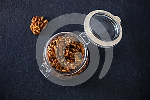 Glass jar with walnut halves photo