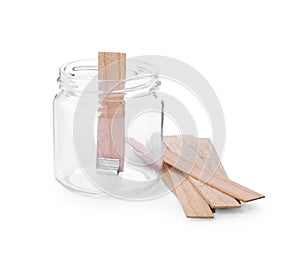 Glass jar and wooden wicks on white background. Making homemade candle