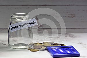 Glass jars with blurred multicurrency coins, calculator and text