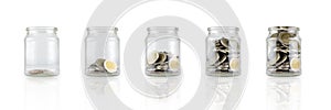 Glass jars with coins like diagram, savings concept