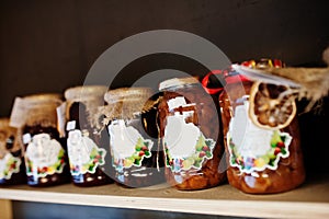 Glass jars with different kinds of jam and berries of a supermarket shelves or grocery store. Homemade canning products. Made with