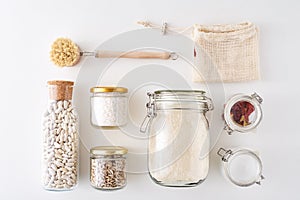 Glass jars with food ingredients on a white background, top view. Zero waste concept. Kitchen background with eco friendly