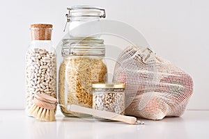 Glass jars with food ingredients on a white background. Zero waste concept. Kitchen background with eco friendly utensils