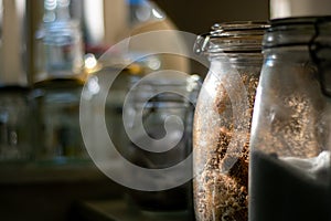 Glass Kilner jars full of provisions in a country kitchen pantry. photo
