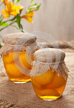 Glass jars with healthy canned peaches compote natural preserved fruits