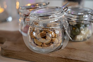 Glass jars with healthy party snacks served in bar, tasty appetisers