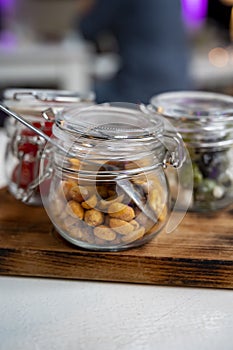 Glass jars with healthy party snacks served in bar, tasty appetisers