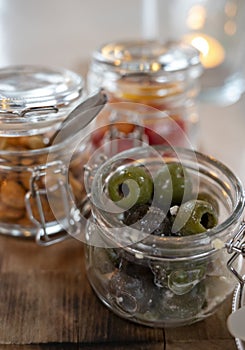 Glass jars with healthy party snacks served in bar, tasty appetisers