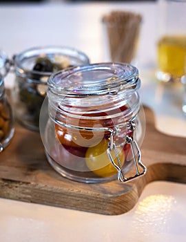 Glass jars with healthy party snacks served in bar, tasty appetisers