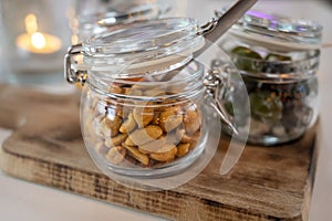 Glass jars with healthy party snacks served in bar, tasty appetisers