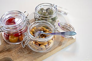 Glass jars with healthy party snacks served in bar, tasty appetisers